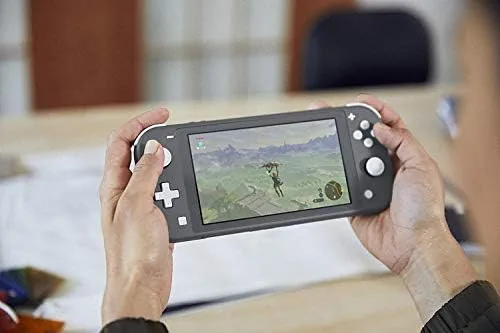 The Switch Lite beside a Switch OLED and a smartphone