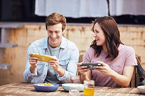 The Switch Lite with a selection of game cases around it