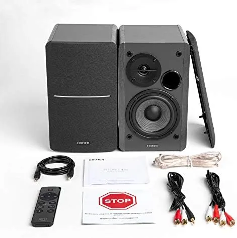 Edifier R1280DBs speakers set up in a small living room with a TV