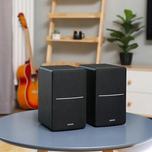 Edifier R1280DBs unboxing showing the two speakers, cables, remote, and manual