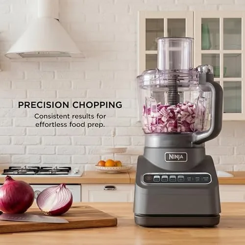 The three blades arranged on a counter beside the food processor bowl