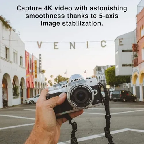 Side by side size comparison of the E-M10 Mark IV and a larger APS-C mirrorless camera