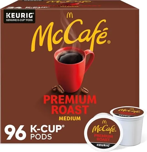 A McCafe Premium Roast K-Cup pod held up to the camera showing the sealed foil lid