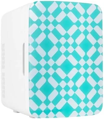 The Cooluli 10L mini fridge with green pattern finish sitting on a bedroom desk