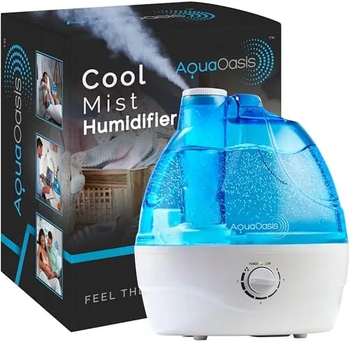 The AquaOasis cool mist humidifier on a bedside table with a glowing mist vent