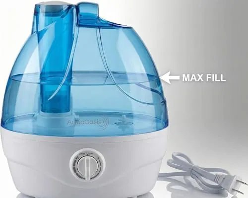 The AquaOasis humidifier misting near a crib in a nursery