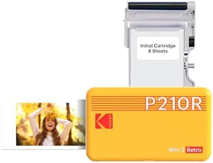 KODAK Mini 2 Retro prints tucked into a scrapbook and journal