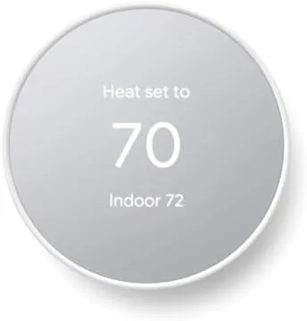 Front view of the Google Nest Thermostat in the Snow finish mounted on a wall