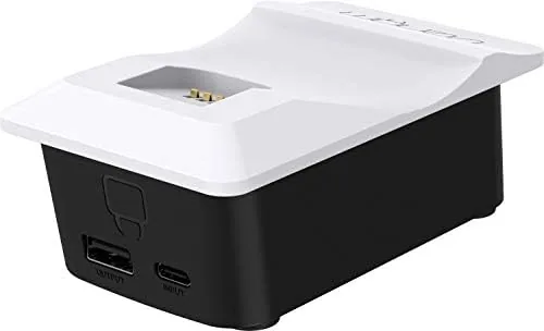 The dock sitting on a shelf beside a PlayStation 5 console