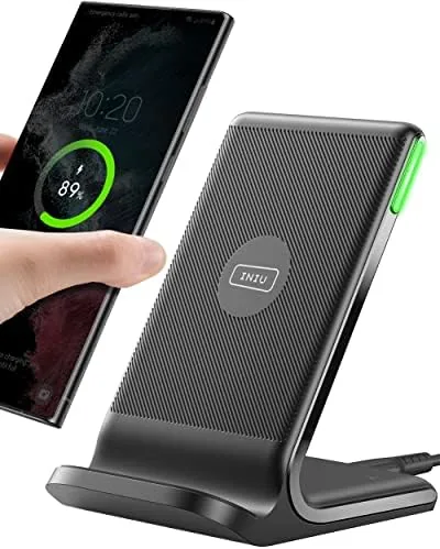 The INIU wireless charger pad on a nightstand with a phone charging