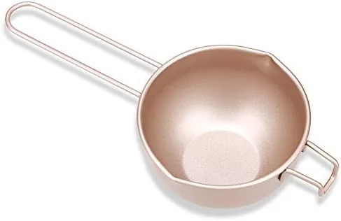 Carbon steel chocolate melting pan with a wooden spoon resting inside