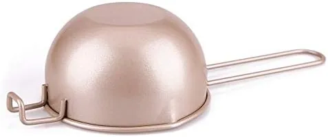 Melted chocolate being poured from the spout over strawberries