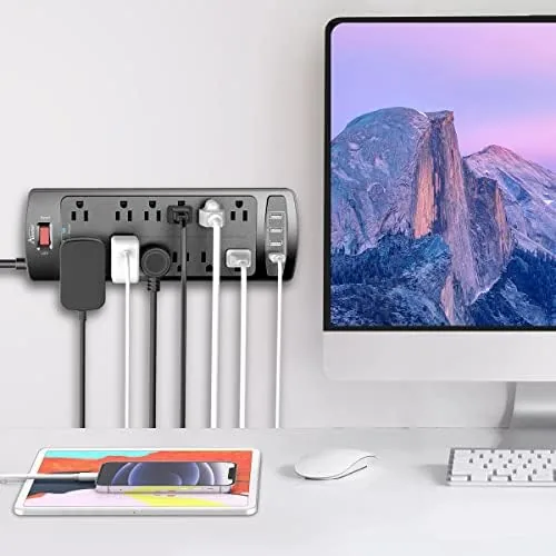 Desktop computer and monitor plugged into the ALESTOR surge protector on a home office desk