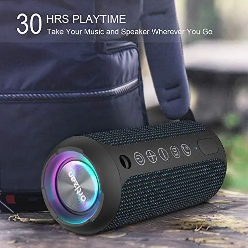 The speaker glowing on a nightstand in a dark bedroom