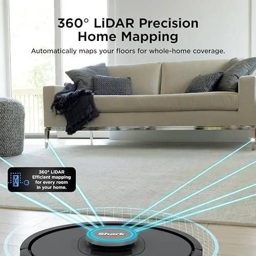 The robot vacuum next to its self-emptying base in a hallway