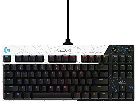 The Logitech G PRO K/DA keyboard with its purple and black theme on a desk