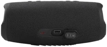 The Charge 5 speaker by a pool with water splashes nearby