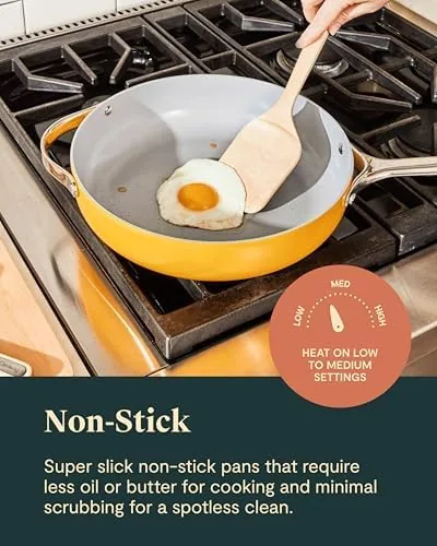 The Caraway set stored in its counter rack next to a budget cookware set
