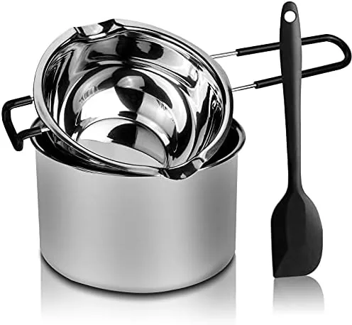 Two stainless steel double boiler pots with a silicone spatula beside them