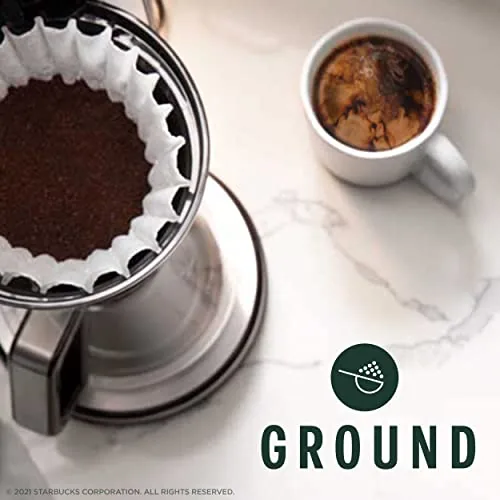 Brewed dark roast coffee in a clear mug showing the deep color