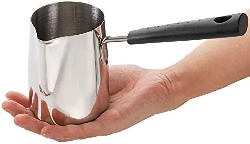 Induction hob heating the 22 ounce pot with milk inside