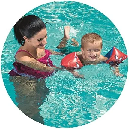 A child wearing the armbands at the edge of a swimming pool