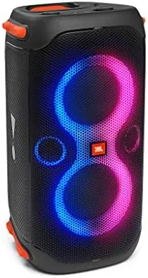 The JBL PartyBox 110 speaker with its light show on in a backyard