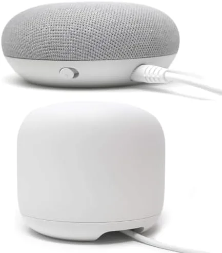 A neatly arranged shelf with a Nest Mini powered by the long cable routed behind it