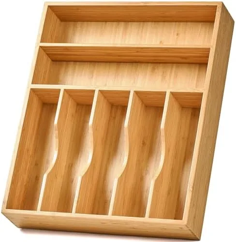 Bamboo drawer organizer with seven slots filled with flatware