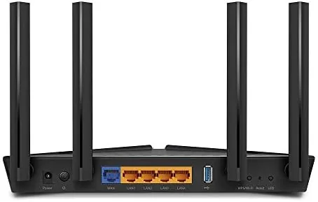 The AX50 router set up next to a modem in a home office
