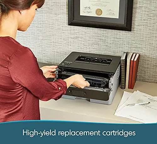 The printer on a bench with toner cartridges laid out for review