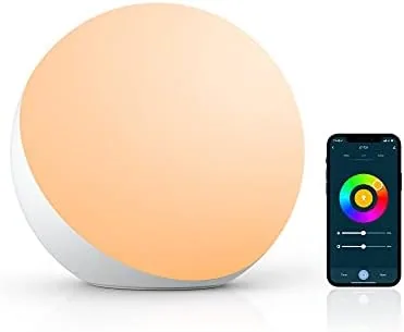 Smart table lamp glowing warm white on a home office desk