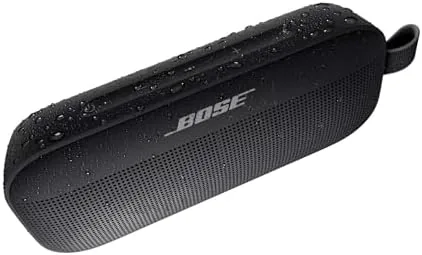 SoundLink Flex speaker beside a towel and sunglasses at a pool