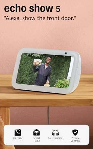 Echo Show 5 Glacier White on a nightstand beside a lamp