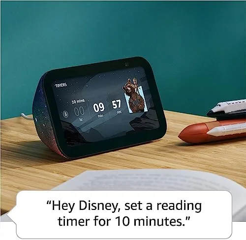 Echo Show 5 Kids beside a stack of children books