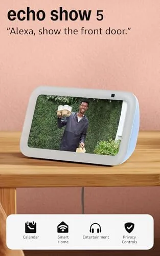 Echo Show 5 Cloud Blue on a desk with a monitor and keyboard