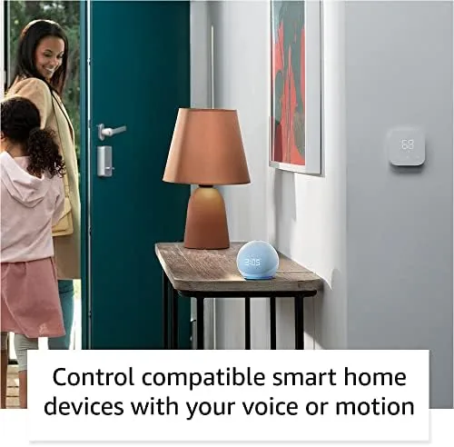 Echo Dot with clock sitting on a nightstand in a dim bedroom
