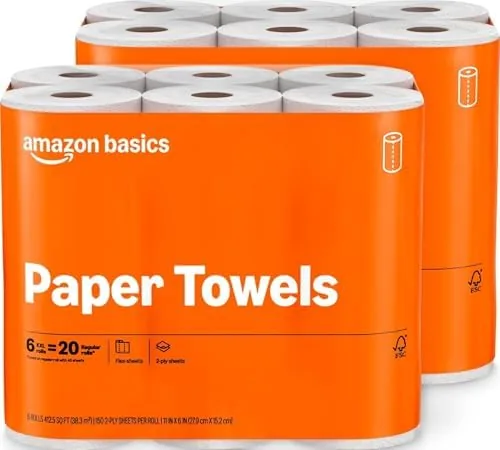 Stack of twelve Amazon Basics paper towel rolls on a counter