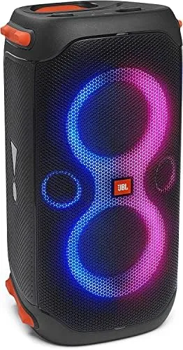 JBL PartyBox 110 speaker with its handle extended and wheels on a patio