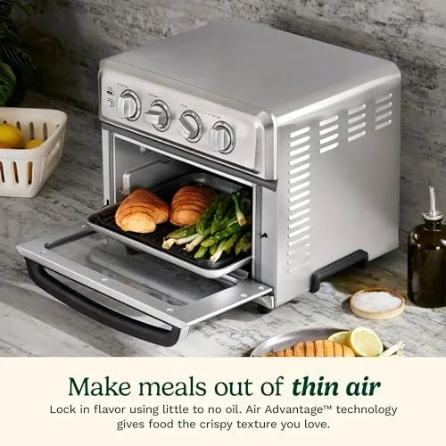 Air fryer basket loaded with seasoned chicken wings