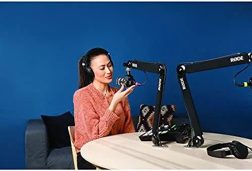A podcaster adjusting the PSA1+ arm during a recording session