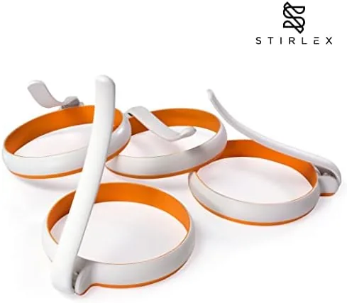 Fried eggs cooking inside the silicone rings