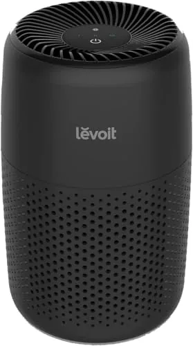 Levoit Core Mini-P air purifier in black on a wooden desk