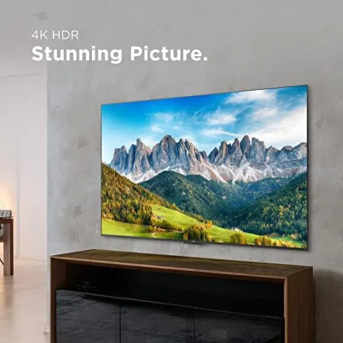 Person watching a sports game on the TCL 4-Series in a living room