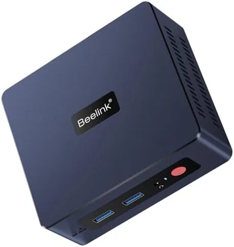 The Beelink SER3 mini PC on a desk next to a monitor