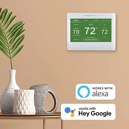 A living room with the thermostat on the wall and an Alexa speaker nearby