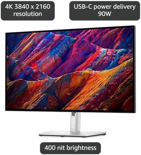 A laptop closed and charging through the monitor while peripherals plug into the hub ports
