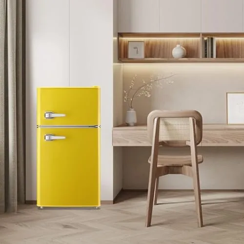 Yellow retro fridge beside a bed in a dorm room