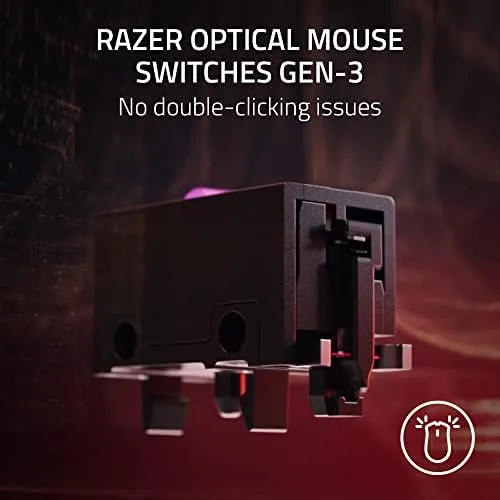 The mouse charging from the included USB-C cable beside a gaming keyboard