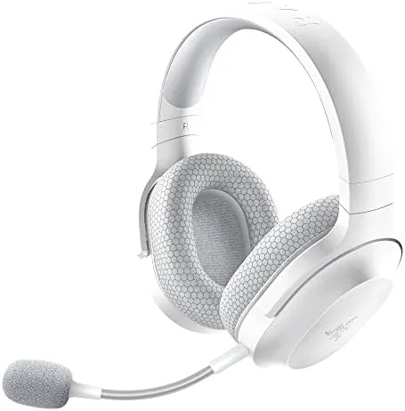 Razer Barracuda X white headset resting on a desk beside a controller